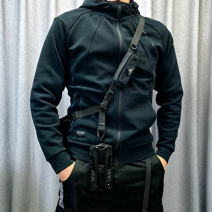 Model wearing the 1101 modular crossbody strap in a crossbody position with attached phone case, showcasing everyday travel setup.
