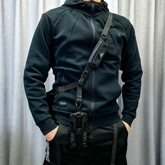 Model wearing the 1101 modular crossbody strap in a crossbody position with attached phone case, showcasing everyday travel setup.
