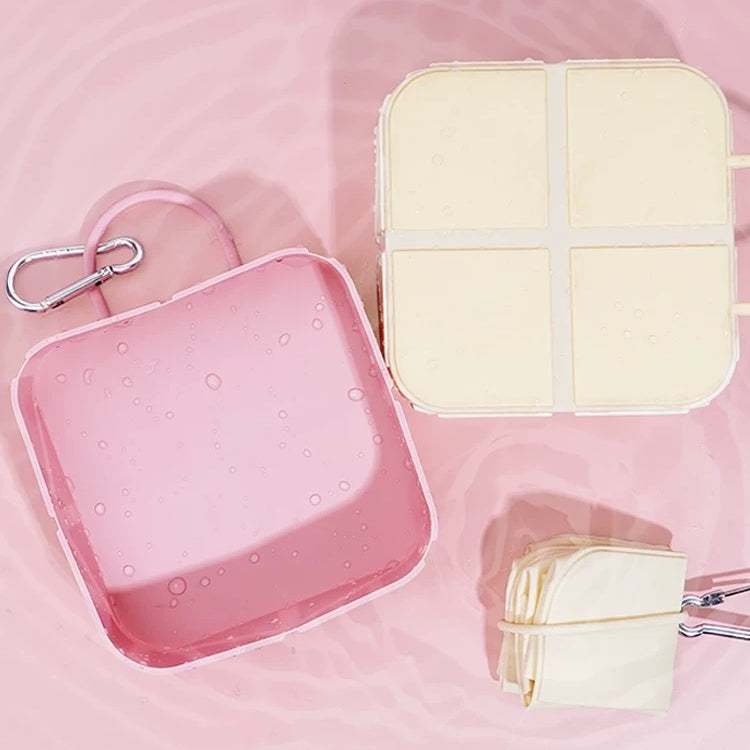 p802 collapsible dog bowls in pink and cream shown expanded and folded on pink water-drop surface, carabiner clips visible