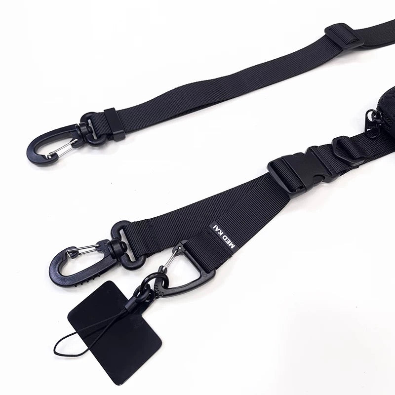 Close-up view of the modular strap’s carabiner hooks and quick-release buckle, highlighting material quality and connector details.
