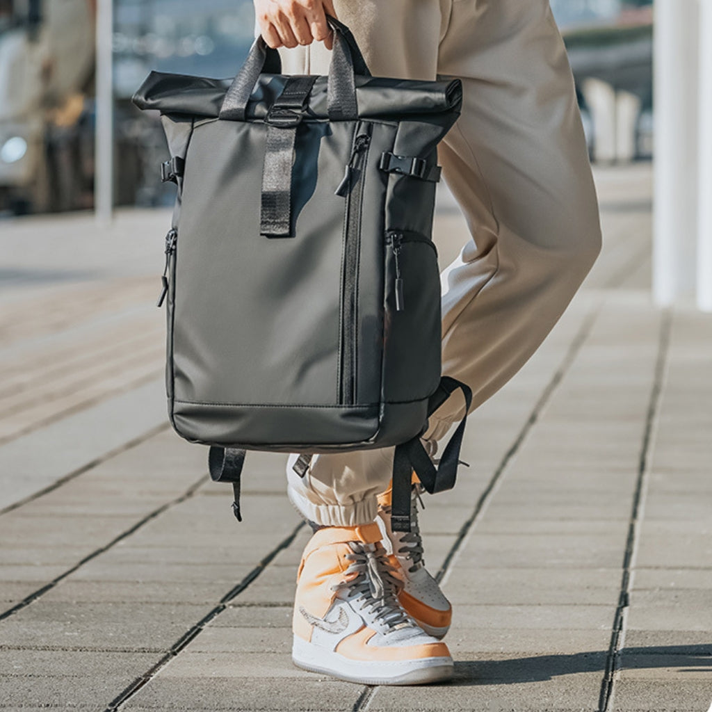 BackpackBeat 7701 waterproof backpack held by hand on the street, showcasing compact form.